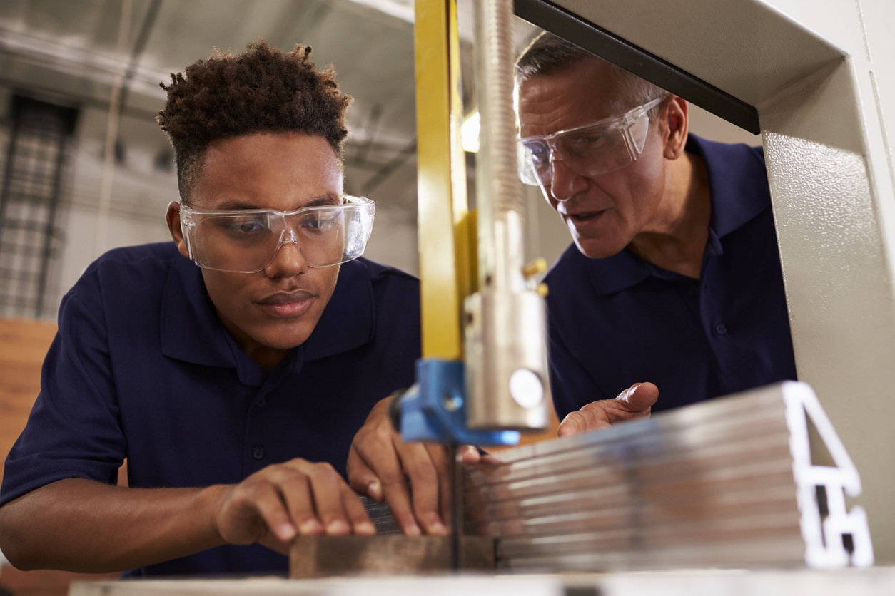 Apprentice using a machine